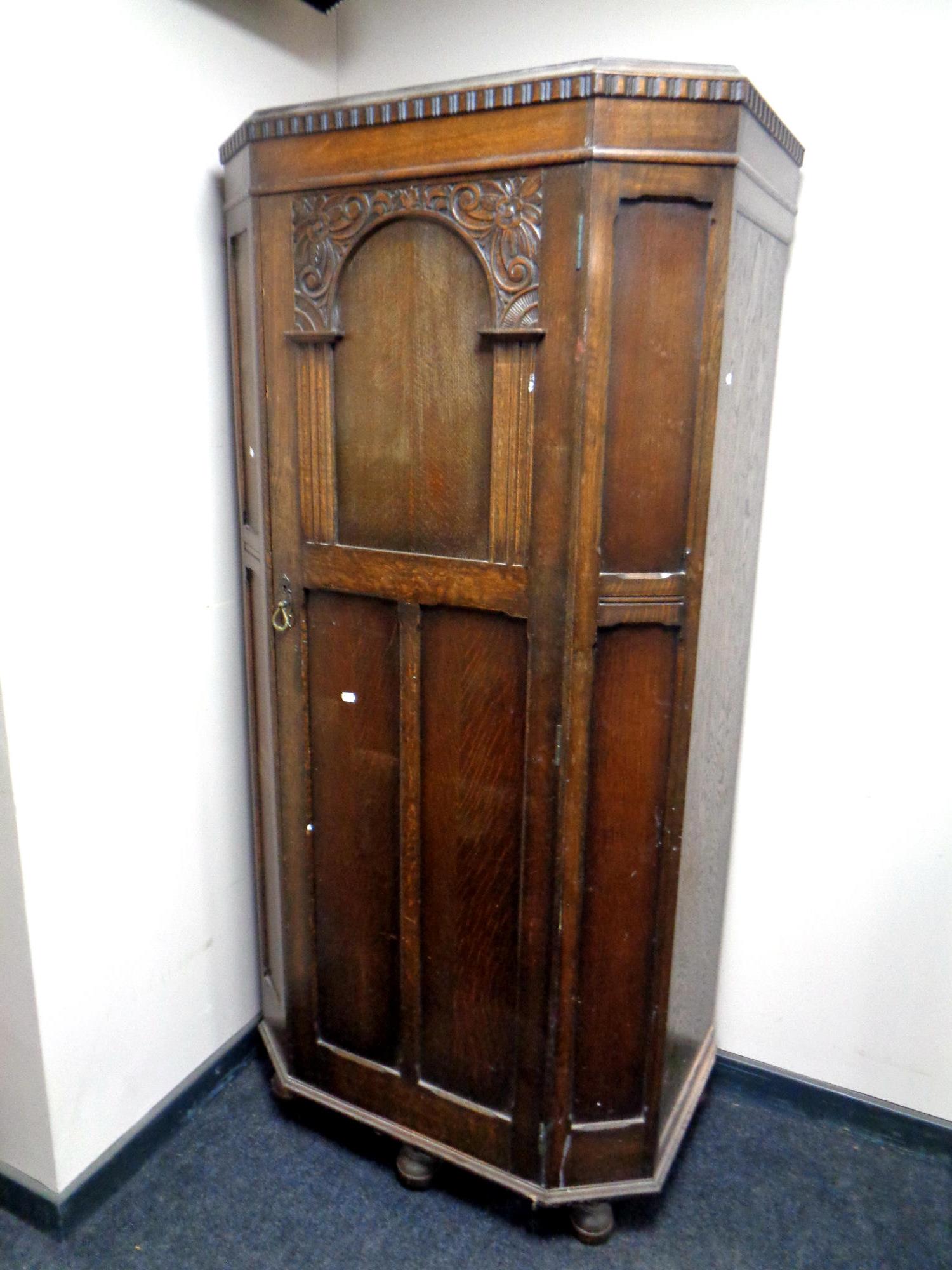 A 20th century carved oak hall wardrobe,