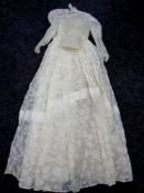 A mid 20th century lace wedding dress together with veil and hair band