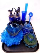 A tray containing antique and later blue glassware to include hand painted jugs,