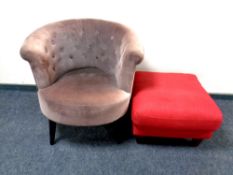 A contemporary button back tub chair together with a footstool upholstered in a red fabric