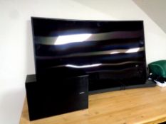 A Samsung 65'' curved TV with sound bar, sub woofer,