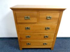 A contemporary oak two over three five drawer chest,
