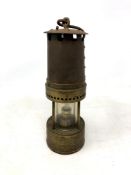 An early 20th century brass miner's lamp