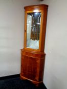A reproduction yew wood corner cabinet,