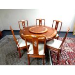 A good quality Chinese hardwood circular dining room table with inlaid mother of pearl decoration,