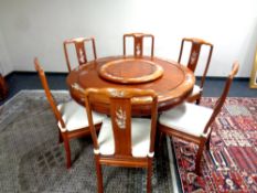 A good quality Chinese hardwood circular dining room table with inlaid mother of pearl decoration,