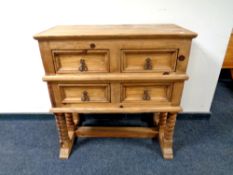A pine four drawer chest on turned legs,