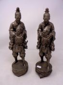 A pair of Japanese white metal warrior figures on plinths