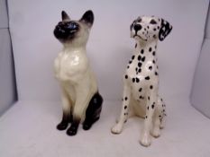 A Royal Doulton figure of a Siamese cat together with a Beswick fireside model of a Dalmation (as
