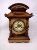 A 19th century beech cased mantle clock with enamel dial