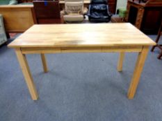 A contemporary oak office table fitted three drawers,