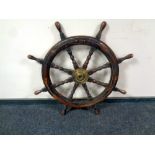 An antique brass mounted ship's wheel,