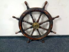An antique brass mounted ship's wheel,
