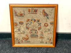 A late nineteenth century woolwork sampler depicting rabbit and other animals with floral