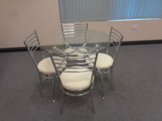 A glass topped metal kitchen table and four chairs,