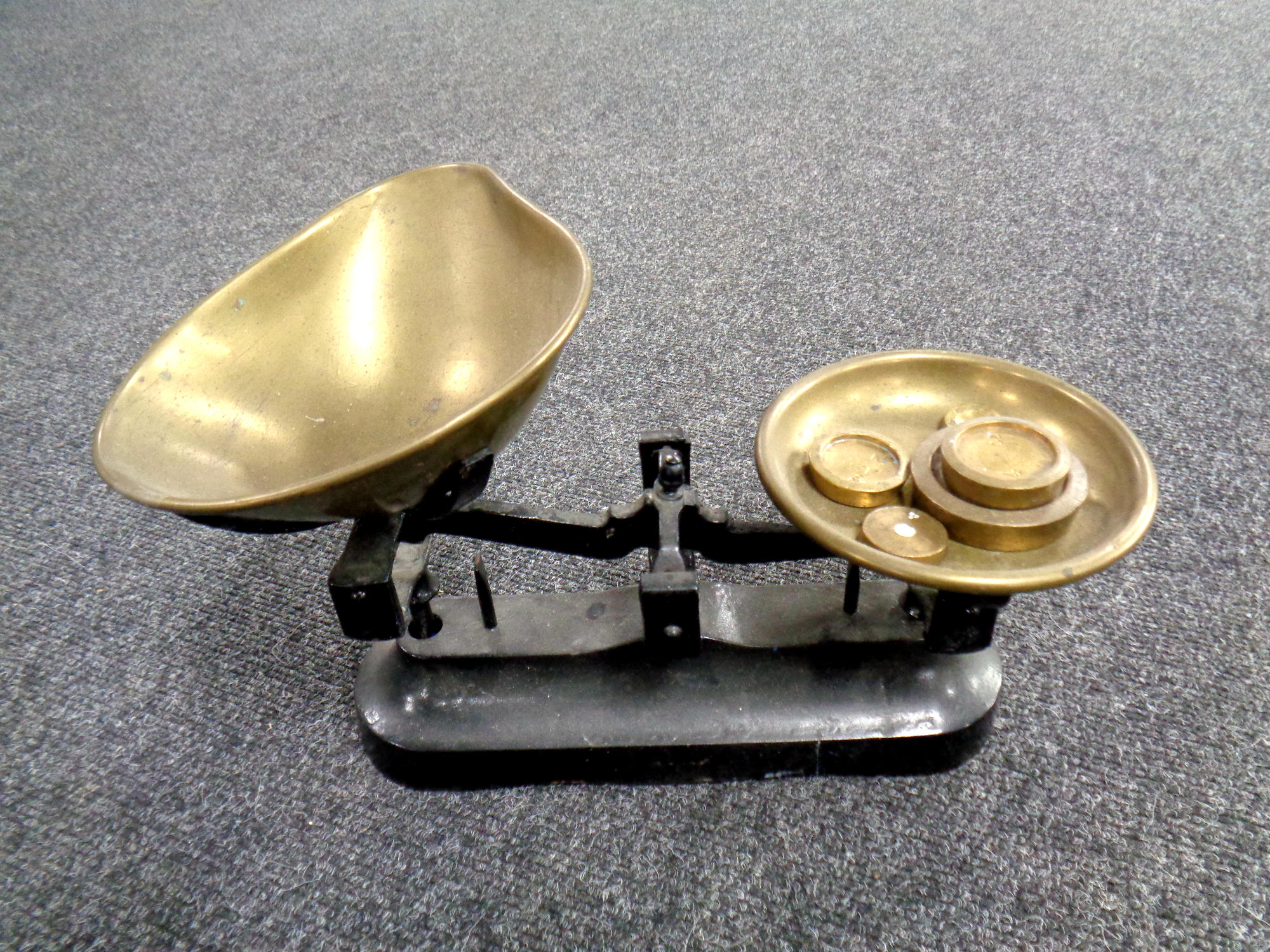 A vintage set of kitchen scales with brass weights