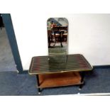 A mid century two tier table together with a rectangular frameless mirror