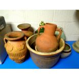 A collection of garden planters and pots, earthenware vases,