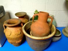 A collection of garden planters and pots, earthenware vases,