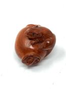 A Japanese carved fruitwood netsuke - Rats on a barrel.