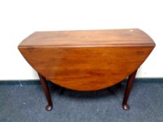 An early 20th century mahogany drop leaf table on pad feet,