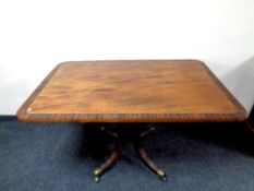 A 19th century inlaid mahogany tilt top breakfast table on four way pedestal base,