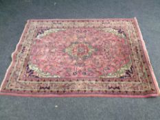 A fringed eastern rug on pink ground