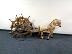 An early 20th century miniature pony with wooden cart with metal wheels