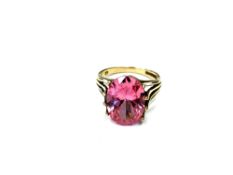 A 9ct yellow gold vibrant pink dress ring, probably synthetic sapphire, size N, 5.2g.