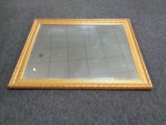 A large gilt framed bevelled overmantel mirror
