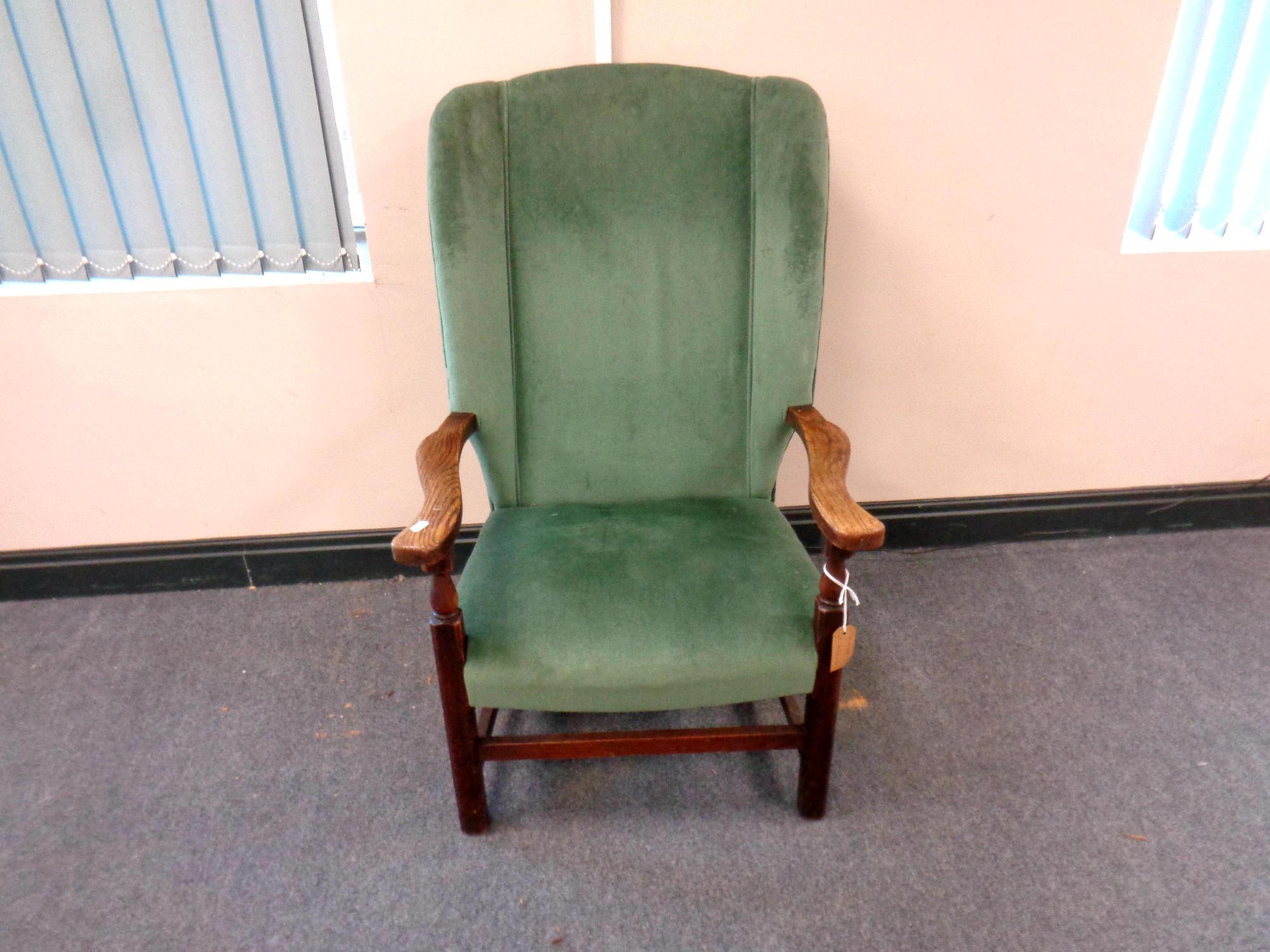 An Edwardian oak framed armchair