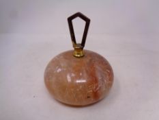 An alabaster curling stone style paperweight