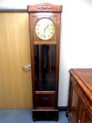 An early 20th century mahogany cased regulator clock with circular brass dial,