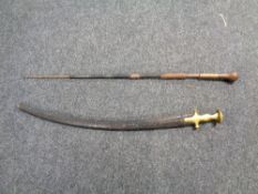 An antique saber with brass hilt together with a further sword in scabbard