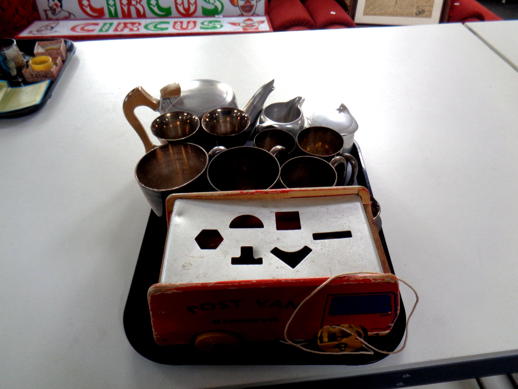 A tray of Picquot ware, stainless tea service, stainless steel and silver plated tankards,