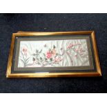 A Japanese silk embroidered panel in a gilt frame depicting a bird of paradise,