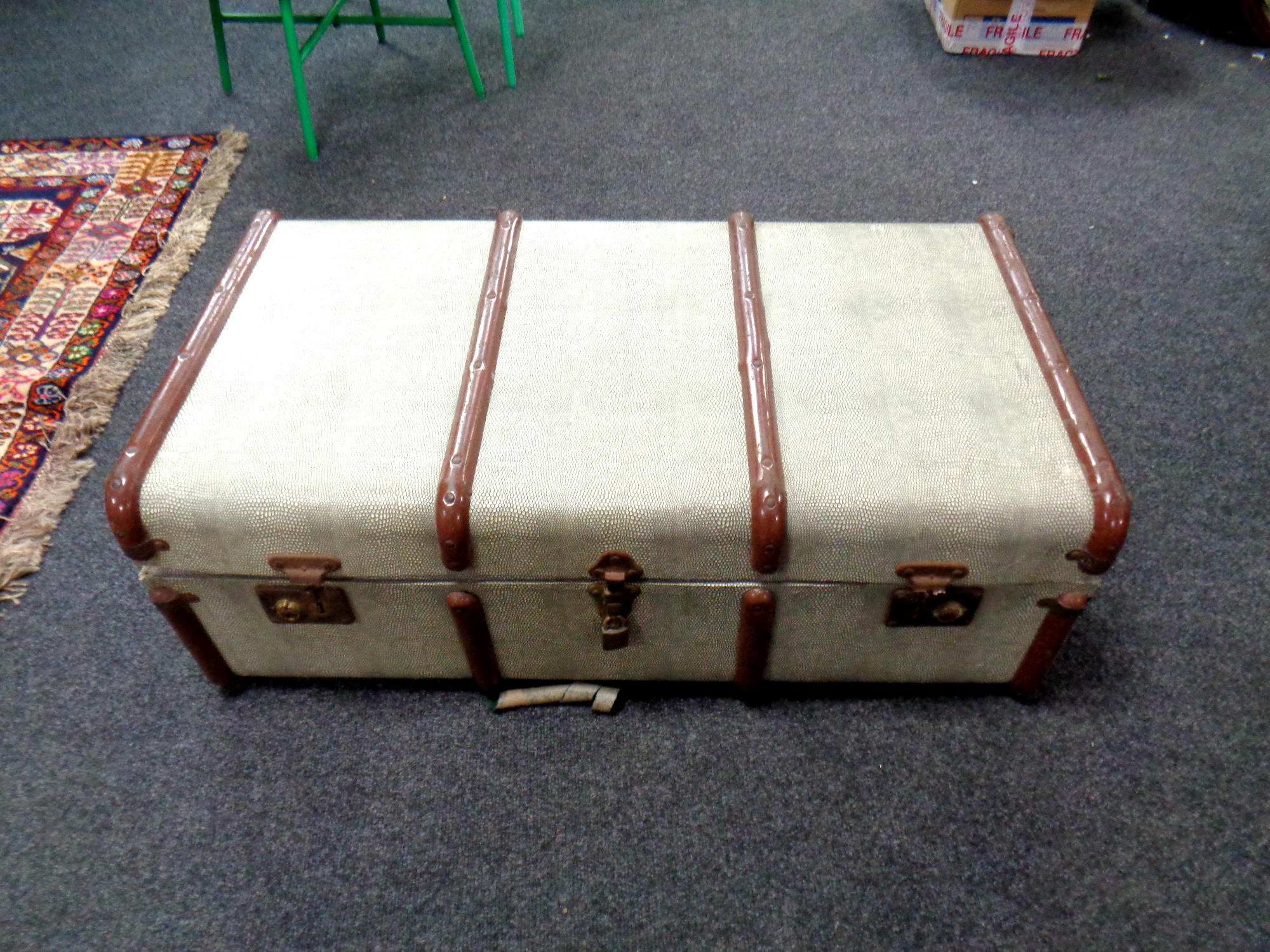 A mid century metal bound trunk