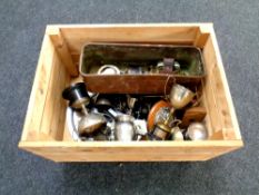 A wooden crate containing a quantity of metalware, brass, small candlesticks, plated trophies,