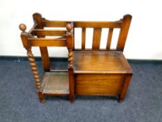 A 1920s oak hall seat with integrated stick stand,