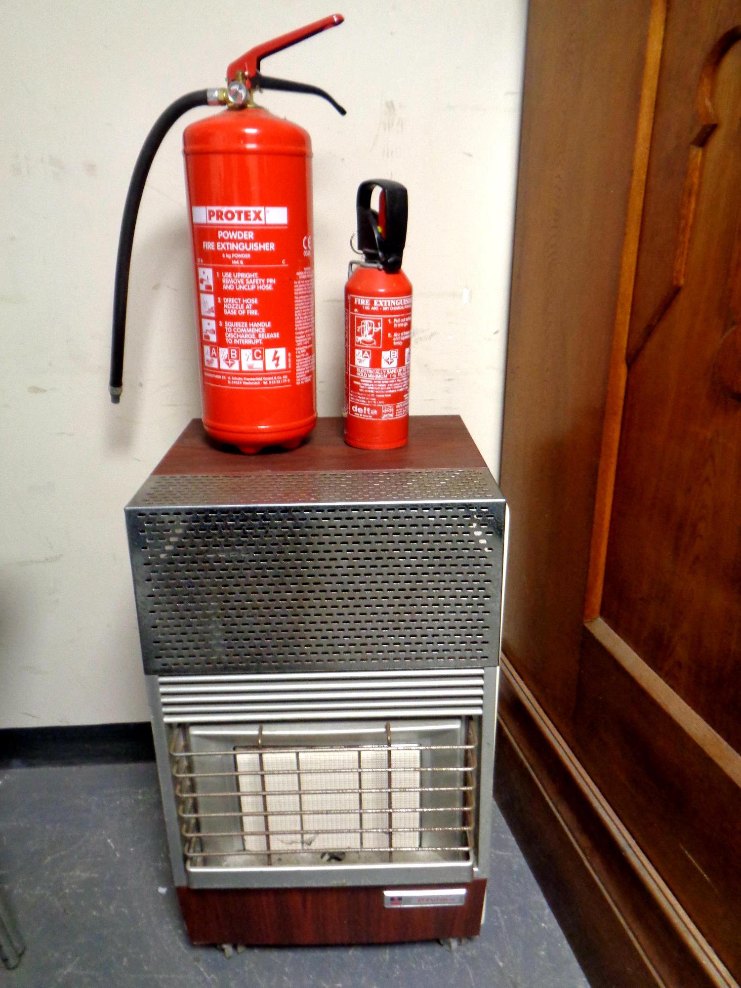 A gas fire together with two fire extinguishers