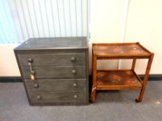 A painted four drawer chest together with a trolley with fruit decoration to top,