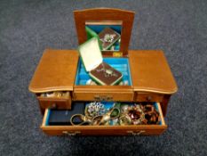 A jewellery box fitted with drawers containing costume jewellery, brooches, necklaces,