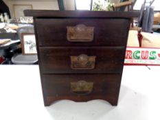 An Edwardian three drawer chest containing tins etc