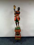 A 20th century painted wooden figural advertising lamp, Light Up Your Day Cigars,