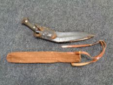 An antique kukri knife in scabbard together with a canvas military style carry case