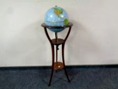 A 20th century revolving globe on mahogany stand,