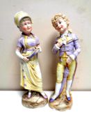 A pair of antique continental bisque figures,