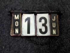 An early 20th century folding metal calendar sign on chain