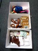 Three boxes containing leather ice skates, carved buffalo figures, picture frames,