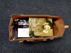 A brown leather holdall containing a large quantity of autograph auction's catalogues